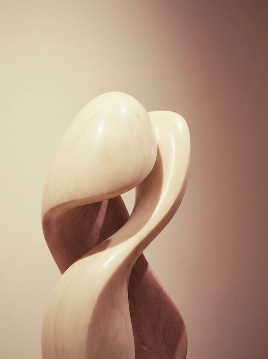 Minimalist abstract sculpture against a soft gradient background